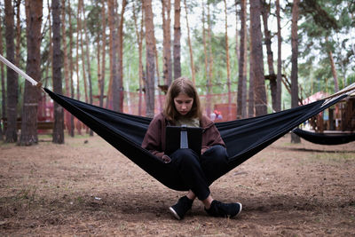 Low angle view of young woman exercising in park