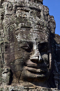 Low angle view of statue against temple