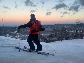 Full length of man skiing on snow covered landscape