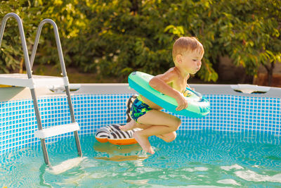 Portrait of boy playing in pool