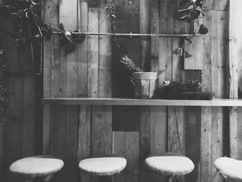 Empty stools by wooden wall at bar