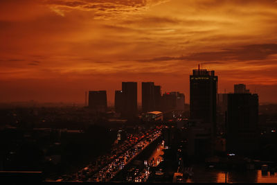 High angle view of illuminated buildings against sky during sunset