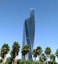 Low angle view of tall building against clear blue sky