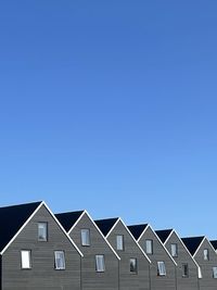 Low angle view of building against blue background