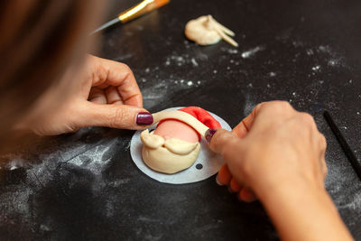 Preparation of a steamed sandwich in the shape of santa claus.