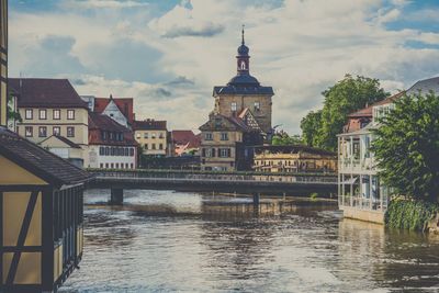 Altes rathaus by river against sky at bamberg