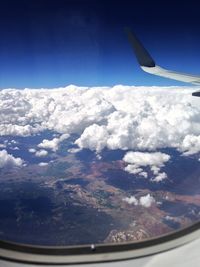 Cropped image of airplane flying over landscape