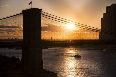 Silhouette bridge against sky during sunset