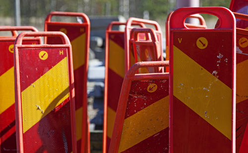 Reflective signs used in road construction stand next to each other