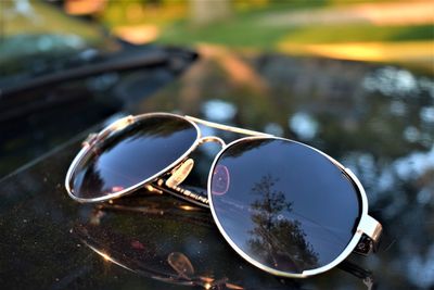 Close-up of sunglasses on vehicle bonnet