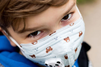Close-up of child wearing kn95 face mask due to coronavirus pandemic.
