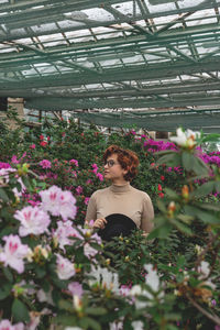 Woman standing in greenhouse