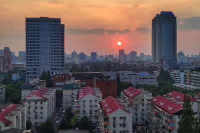 View of buildings in city during sunset