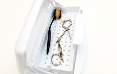 High angle view of stethoscope against white background