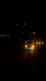 Car on illuminated road at night