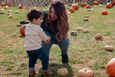 Mom and son in the pumpkin's garden