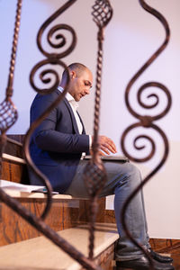 Rear view of man sitting on chair