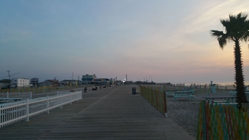Pier over sea against sky during sunset