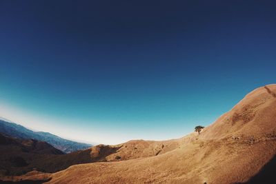 Scenic view of mountains against clear blue sky