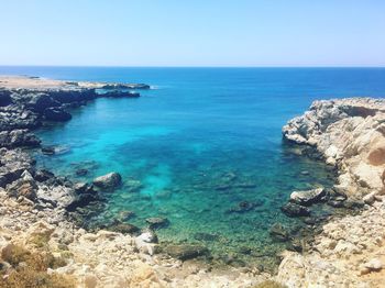 Scenic view of sea against clear blue sky