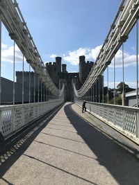 Bridge in city against sky