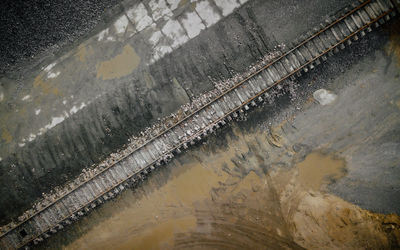 High angle view of wet road by river