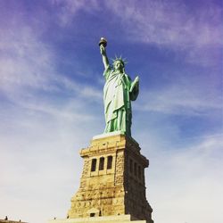 Low angle view of statue against cloudy sky