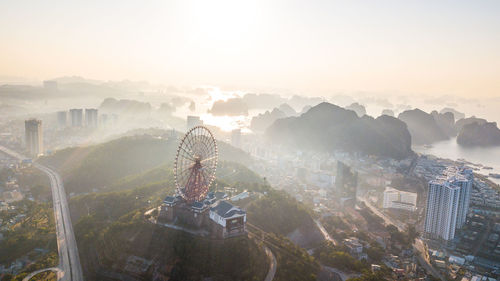 Aerial view of statue amidst buildings in city