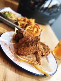High angle view of fried chicken wings in plate on table