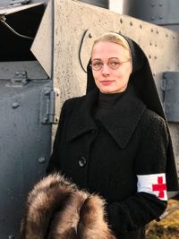 Portrait of nun standing outdoors