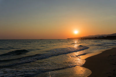 Scenic view of beach against sky during sunset