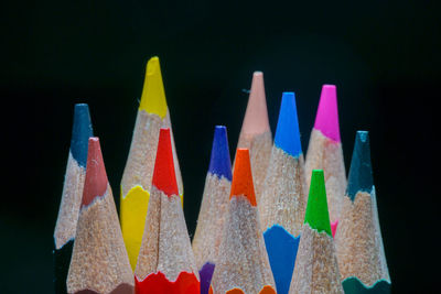 Close-up of multi colored pencils against black background