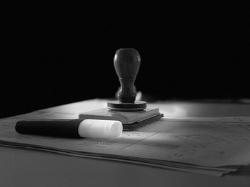 Close-up of book on table against black background