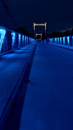 Surface level of illuminated bridge at night