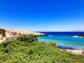 Scenic view of sea against clear blue sky