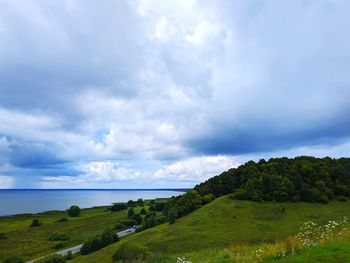 Scenic view of landscape and sea against sky