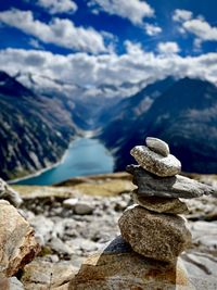 Stack of pebbles on mountain against sky