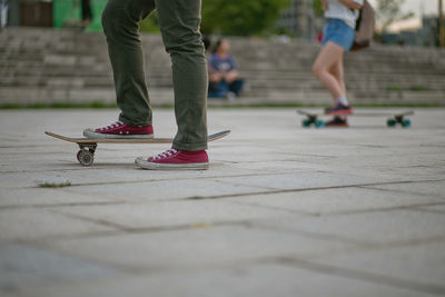 Low section of people skateboarding at park