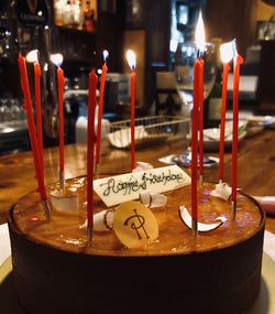 Close-up of lit candles on table