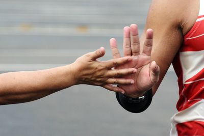 Close-up of people giving high five