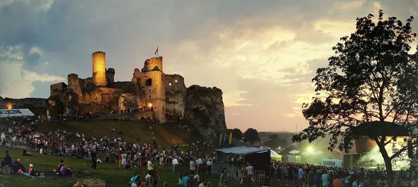 Panoramic view of people at town square during sunset