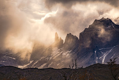 Mystic light mood backlit at torres del paine national park with clouds and mountains, chile