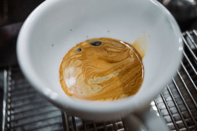 Latte art coffee on wooden table in coffee shop