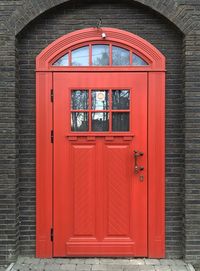 Beautiful red door in a brick wall