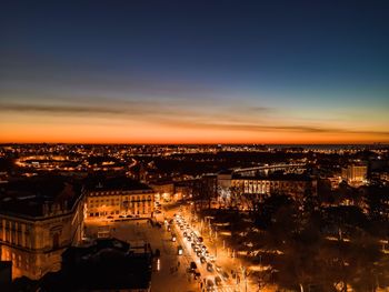 High angle view of illuminated buildings against sky during sunset