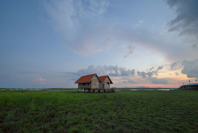 House on field against sky