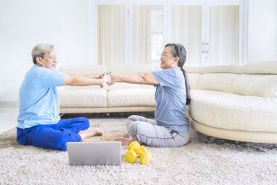 Happy woman sitting on sofa