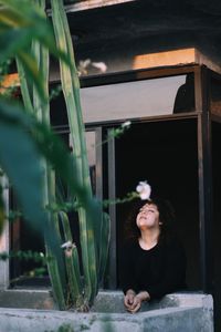 Portrait of young woman out the window at sunset