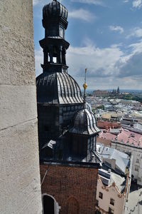 View of buildings against cloudy sky