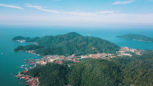 High angle view of cityscape by sea against sky